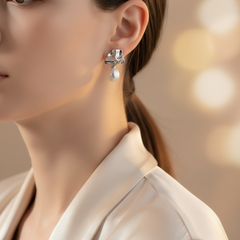 Close-up of a woman wearing Silver Lava Pearl Drop Dangles