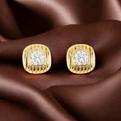 A pair of 925 sterling silver gold-plated square stud earrings with sparkling zircon stones, displayed on a brown textured surface.
