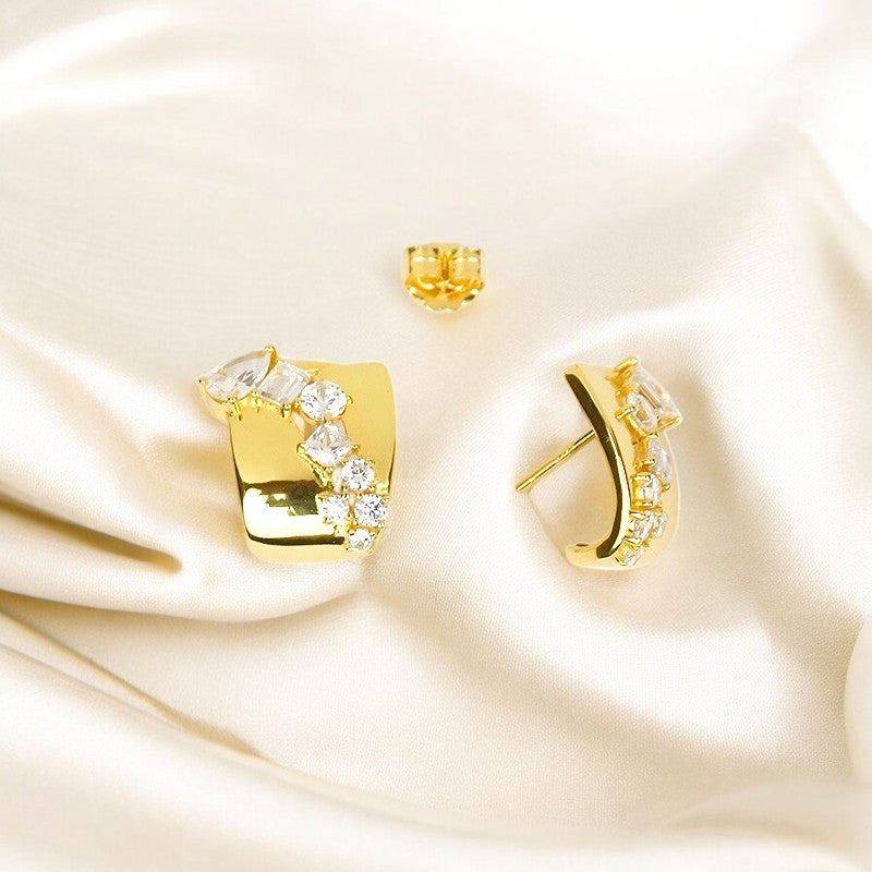 A pair of 925 sterling silver golden modern statement stud earrings with a polished square base and sparkling zircon stones