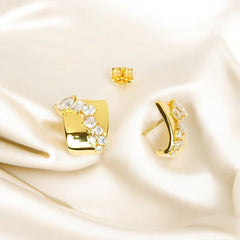 A pair of 925 sterling silver golden modern statement stud earrings with a polished square base and sparkling zircon stones