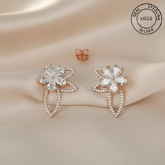 Pair of silver earrings with floral design featuring 'Real Sterling Silver' stamp.