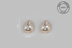 Pair of teardrop-shaped earrings with rose gold setting , featuring 'Real Sterling Silver 925' certification.