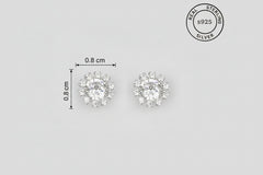 Pair of silver earrings with CZ diamonds, showing size measurement.