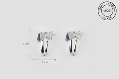 Silver earrings with blue stones and size measurement on a white background