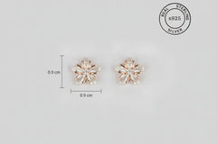 Pair of silver flower-shaped earrings with 'Real Sterling Silver 925' stamp on a light gray background.