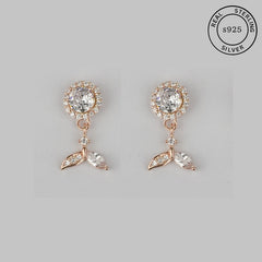 A pair of rose gold 925 sterling silver drop earrings with a floral design and cubic zirconia stones.
