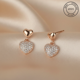 Heart-shaped earrings with rose gold and AAA+ Cubic zircons featuring 'Real Sterling Silver 925' stamp.