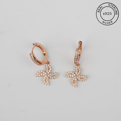 A pair of rose gold charm hoop earrings with a pinwheel design, crafted from 925 sterling silver and featuring cubic zirconia stones.