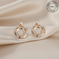 Rose gold earrings with diamonds on , featuring 'Real Sterling Silver' stamp.