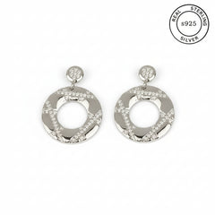 Pair of silver earrings with circular design on a white background, featuring 'Real Sterling S925' label.