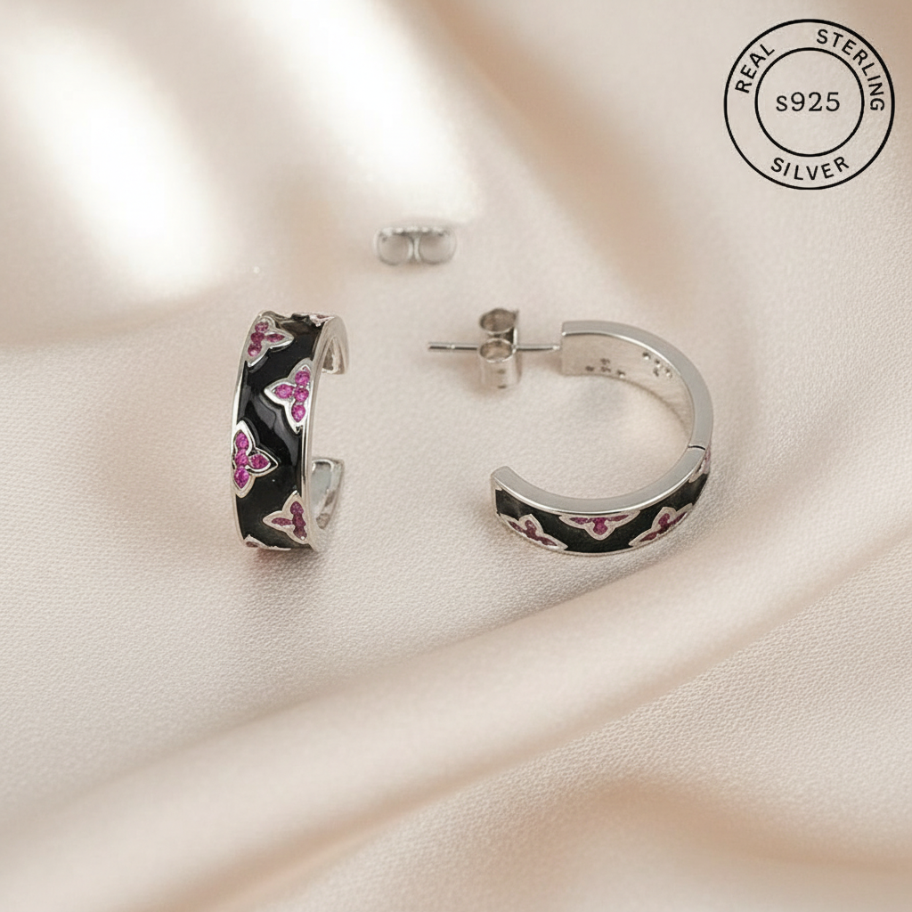 Silver hoop earrings with black and pink floral design featuring 'Real Sterling Silver' stamp.