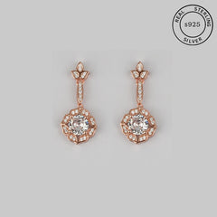 A pair of vintage drop dangle earrings with a floral-inspired design, featuring a rose gold finish and sparkling center stones, crafted from 925 sterling silver.