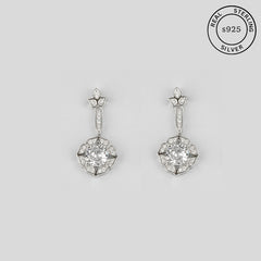 A pair of 925 sterling silver vintage drop dangle earrings with floral-inspired design and a sparkling center stone.