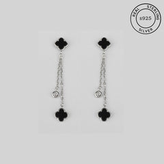 A pair of 925 sterling silver earrings featuring a clover design with dual-chain drops and black enamel charms.