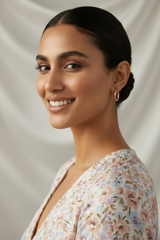 Woman with a stylish hair bun wearing 925 Sterling Silver Rosegold Twist Hoop Earrings