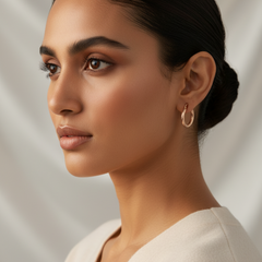 Close-up of a woman wearing925 Sterling Silver Rosegold Twist Hoop Earrings