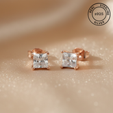 Rose gold stud earrings with AAA+ cubic zircona diamonds, featuring a 'Real Sterling Silver 925' stamp.