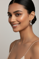 Woman wearing 925 Sterling Silver Heart Hoop Huggie Earrings
