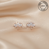 Rose gold earrings with AAA+ CZ on a beige fabric background, featuring 'Real Sterling Silver 925' label.