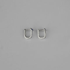 Pair of silver hoop earrings on a gray background