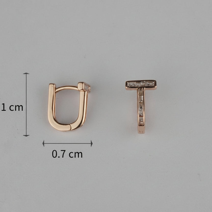 Rose gold hoop earring and 'T' shaped earring with measurements on a gray background