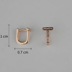Rose gold hoop earring and 'T' shaped earring with measurements on a gray background