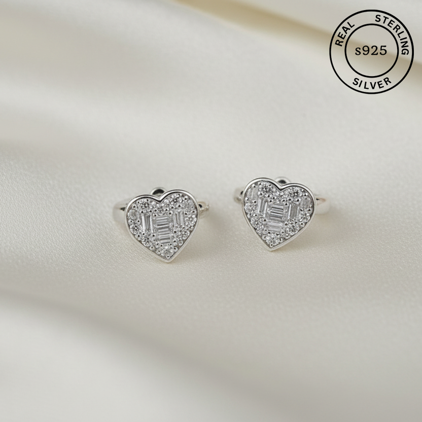 Heart-shaped silver earrings with clear stones on a light background, labeled 'Real Sterling Silver s925'.