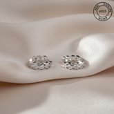 Silver hoop earrings on a soft fabric background with 'Real Sterling Silver' stamp.