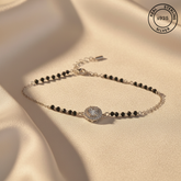 925 Sterling Silver Black Bead Halo Bracelet with black beads on a beige fabric background, featuring 'Real Sterling Silver' stamp.