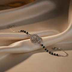 925 Sterling Silver Black Bead Halo Bracelet with black beads and silver clasp on beige fabric
