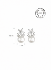 Pearl earrings with crystal accents and size measurements on a white background