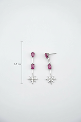 Pair of earrings with pink gemstones and star-shaped drops on a white background