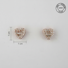 Heart-shaped earrings with clear stones accompanied by a measurement scale and '925 Sterling Silver' stamp.