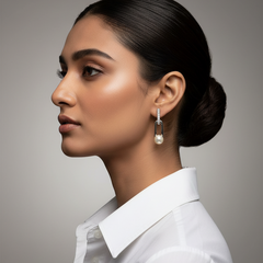 Woman wearing a white shirt and pearl earring