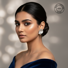 Woman wearing silver earrings with a blurred background and 'Real Sterling Silver' logo.
