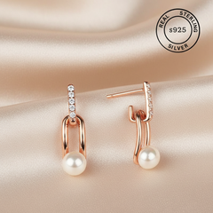 Rose gold earrings with pearls and diamonds featuring 'Real Sterling Silver' stamp