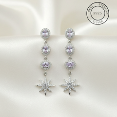 Silver earrings with purple gemstones on a white background, featuring 'Real Sterling Silver' certification.