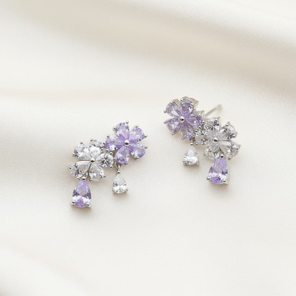 Pair of purple floral earrings on a light background