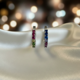 Pair of silver hoop earrings with colorful stones on a white fabric background, featuring a 'Real Sterling Silver 925' stamp.