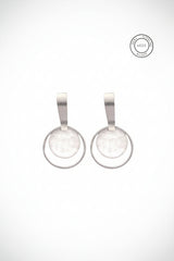 Pair of silver earrings with circular designs on a white background