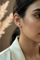 woman wearing a 925 sterling silver blue gemstone earring