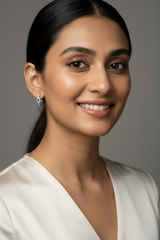 Woman wearing 925 Sterling Silver Emerald Green Grace Hoop Earrings