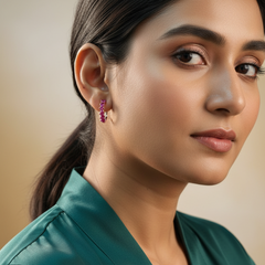 Woman wearing pink earrings with a blurred background