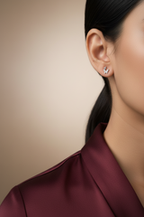 Close-up of a person wearing 925 Sterling Silver Dual Butterfly Studs