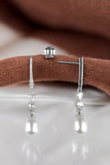 A pair of silver pearl drop dangling earrings 