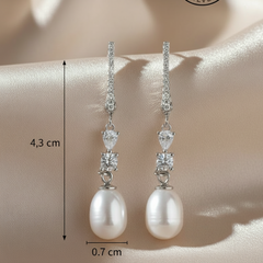 Pearl earrings with crystal accents on a mannequin, showing measurements.