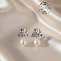 Silver Lava Pearl Drop Dangles with pearls on a satin surface, featuring 'Real Sterling Silver' certification.