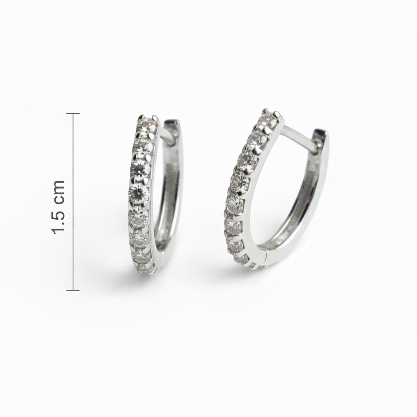 Silver hoop earrings with embedded stones on a white background