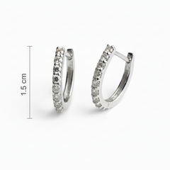 Silver hoop earrings with embedded stones on a white background