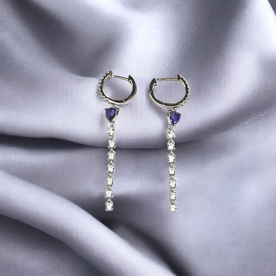A pair of silver hoop earrings with sapphire blue accents